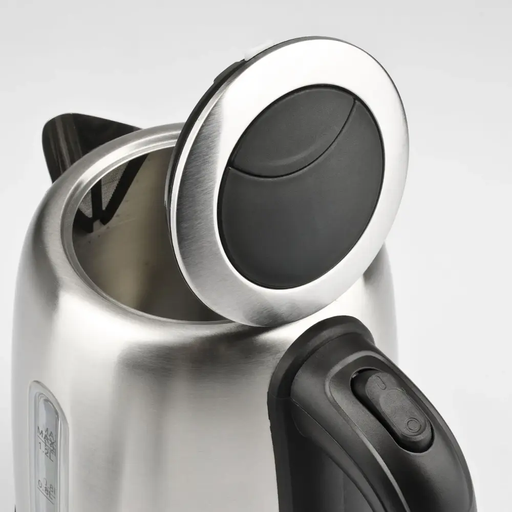 Open-lid close-up of the stainless steel G3 Ferrari 1.2L Idra G10095 kettle, showing its black handle and silver-rimmed lid