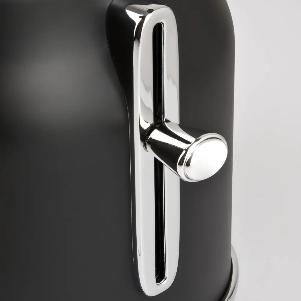 Close-up of the G3 Ferrari Artista black toaster showing its shiny chrome browning control lever against a light gray