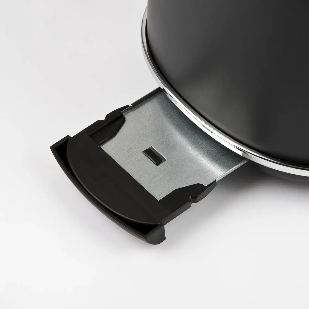 Close-up of the G3 Ferrari Artista Toaster’s black removable crumb tray and metal base, against a white background.