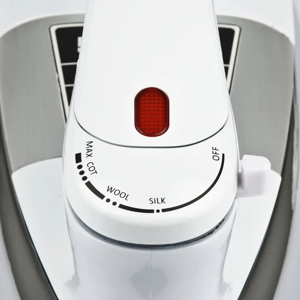 Top-down close-up of the white G3 Ferrari 900W Dry Iron Seicento G40013, showing its red indicator and fabric-setting dial on