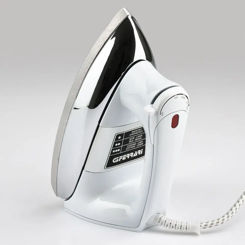 G3 Ferrari 900W Dry Iron Seicento G40013 shown upright at an angle, with white body, silver soleplate and cord on a light
