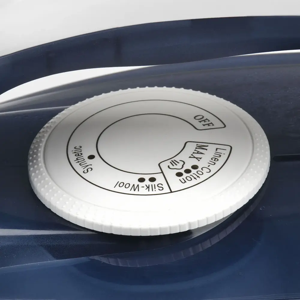 Close-up of the white temperature dial on the dark blue G3 Ferrari 2000W Steam Iron with Ceramic Soleplate, Opera G40014.