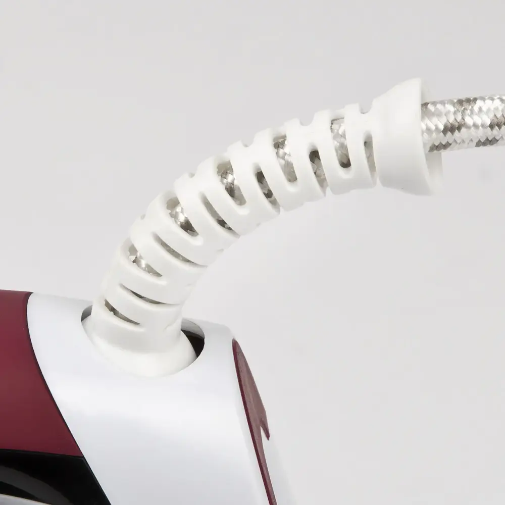 Close-up of the white coiled power cord and burgundy-and-white handle of the G3 Ferrari 2200W Steam Iron on a light