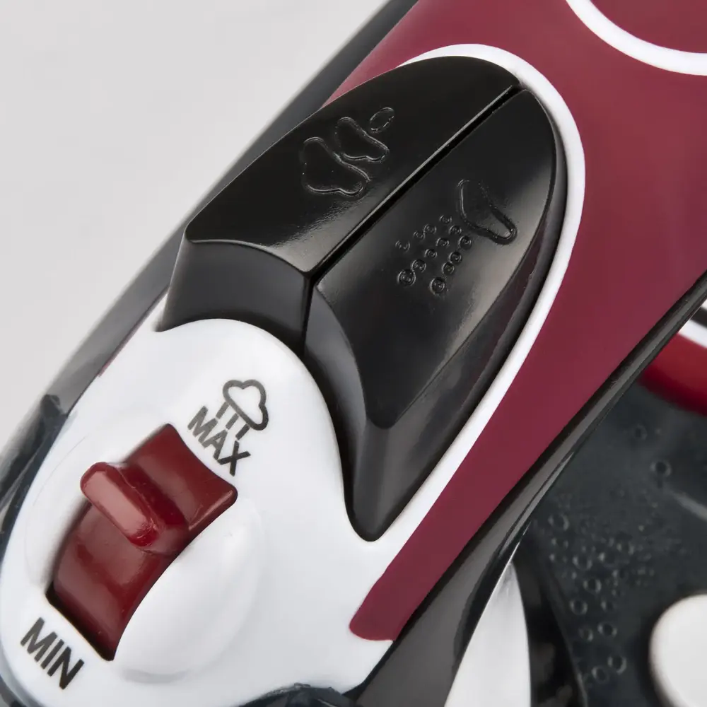 Close-up angled view of the G3 Ferrari Califfo G40017 steam iron’s black steam controls and red MIN–MAX slider on a white and